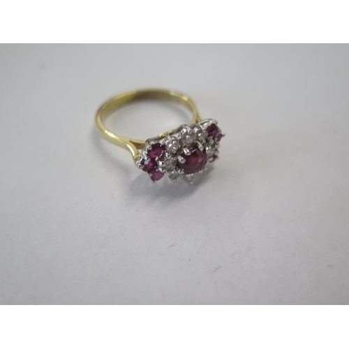 13 - A yellow gold diamond and ruby type cluster ring - surface tests to approx 18ct - with a central sto... 