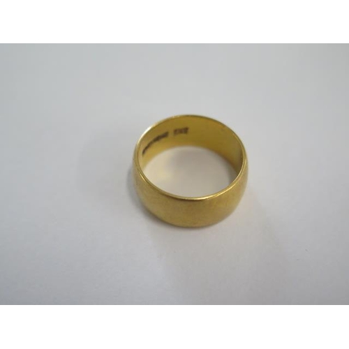 33 - A hallmarked 22ct yellow gold band ring size N - 8mm band - approx weight 9.4 grams - some usage mar... 