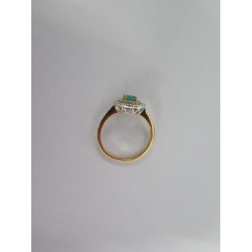 38 - A hallmarked 18ct yellow gold emerald and diamond Halo ring size O - the central emerald approx 0.48... 