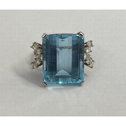 40 - A good aquamarine and diamond white metal ring (possibly platinum) the large emerald cut aquamarine ... 