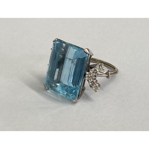 40 - A good aquamarine and diamond white metal ring (possibly platinum) the large emerald cut aquamarine ... 