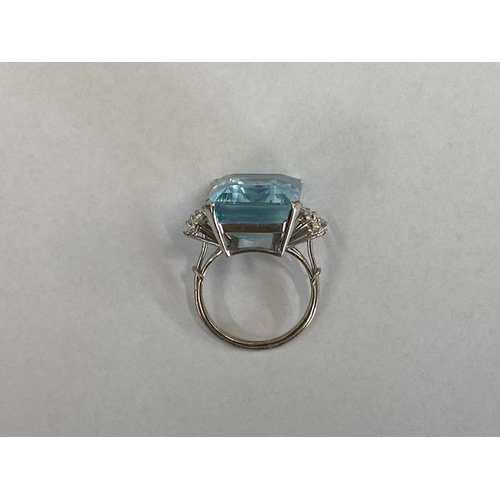 40 - A good aquamarine and diamond white metal ring (possibly platinum) the large emerald cut aquamarine ... 