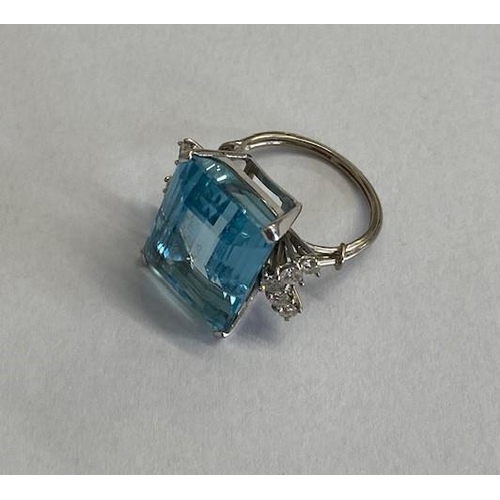 40 - A good aquamarine and diamond white metal ring (possibly platinum) the large emerald cut aquamarine ... 