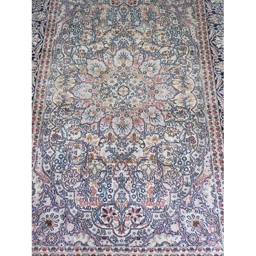 521 - A fine woven silk mix rug with cream field foliate centre with stylized boarder - 192cm x 122cm - so... 