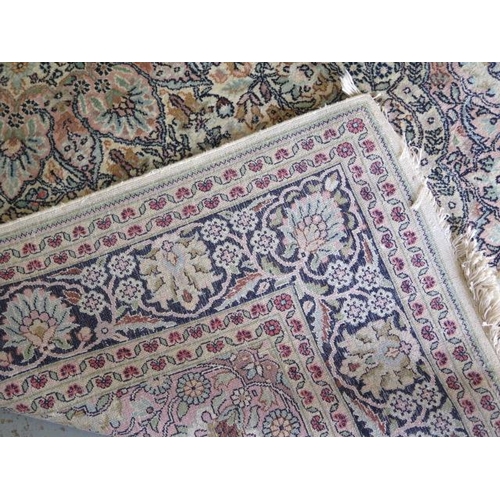 521 - A fine woven silk mix rug with cream field foliate centre with stylized boarder - 192cm x 122cm - so... 