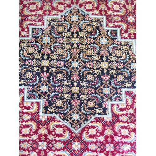 522 - A fine woven silk mix rug with a red field, central medallion and stylized boarder - 192cm x 121cm -... 