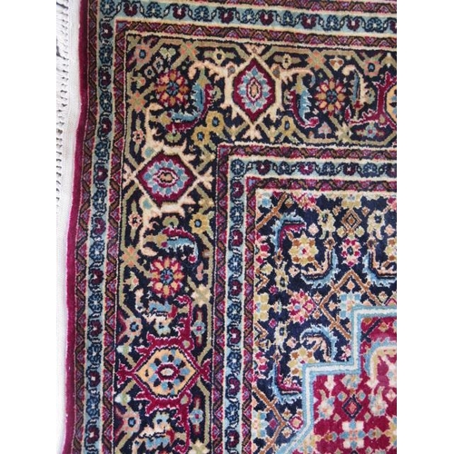 522 - A fine woven silk mix rug with a red field, central medallion and stylized boarder - 192cm x 121cm -... 