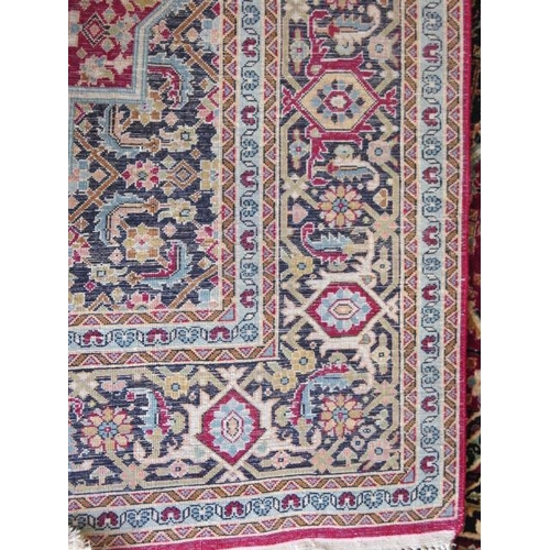 522 - A fine woven silk mix rug with a red field, central medallion and stylized boarder - 192cm x 121cm -... 