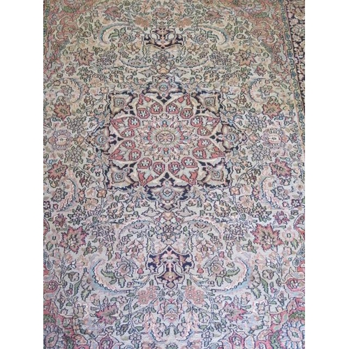 523 - A fine woven silk mix rug with cream field and dark blue boarder - 192cm x 123cm - some slight wear ... 