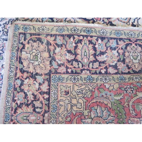 523 - A fine woven silk mix rug with cream field and dark blue boarder - 192cm x 123cm - some slight wear ... 