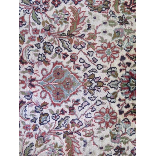 525 - A fine woven silk mix rug with cream field and foliate design - 196cm x 120cm - some wear mainly to ... 