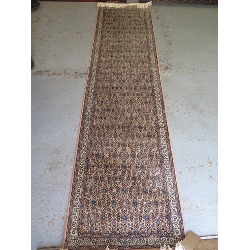 526 - A woven runner rug with a faded pink field - 315cm x 78cm - some fading but generally good