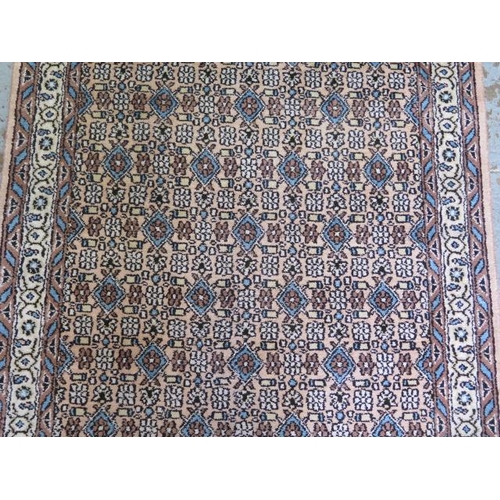 526 - A woven runner rug with a faded pink field - 315cm x 78cm - some fading but generally good