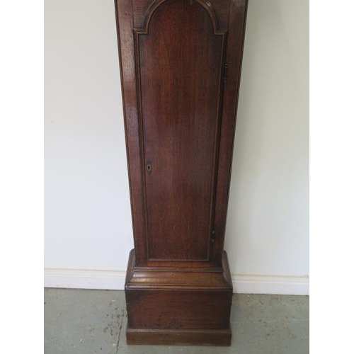 541 - An oak 8 day striking longcase clock with a brass arched 12