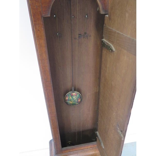 541 - An oak 8 day striking longcase clock with a brass arched 12