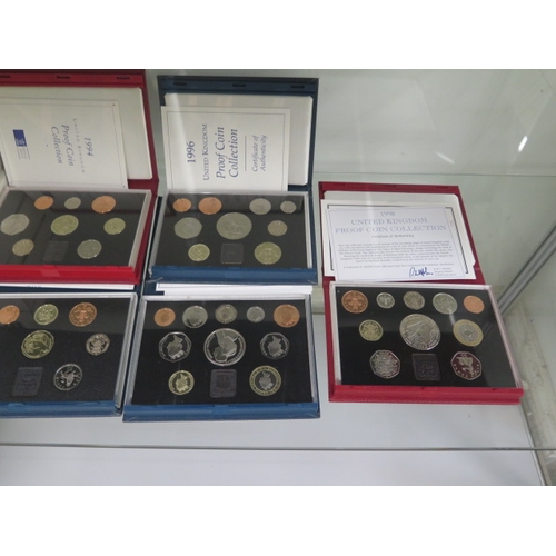 205 - Sixteen United Kingdom proof coin sets running from 1984 to 1998 with a duplicate 1993 set