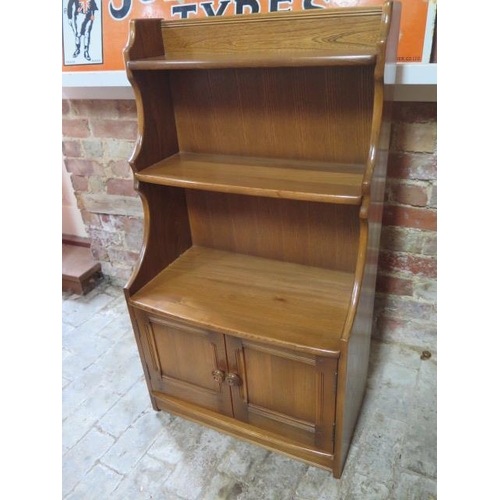 617 - An Ercol waterfall bookcase with two base drawers - Height 102cm x Width 61cm