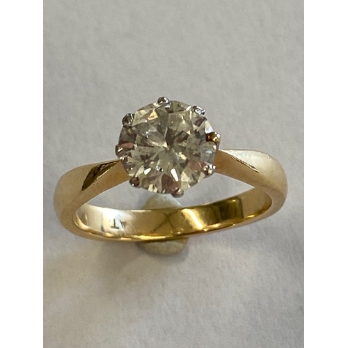 1 - An 18ct yellow gold and platinum solitaire diamond ring - the round brilliant cut diamond approx 1.5... 