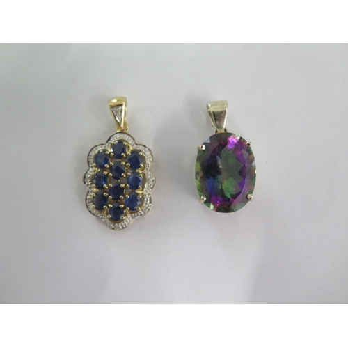 119 - A 9ct white gold Mystic Topaz pendant and a 9ct yellow gold sapphire and diamond pendant - 30mm and ... 