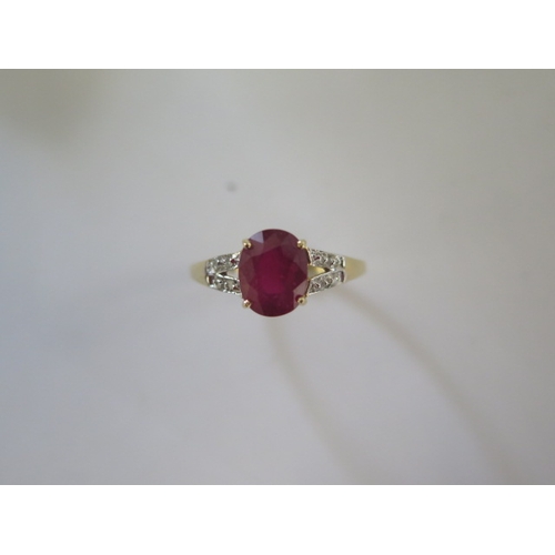 135 - A 9ct yellow gold ruby and diamond ring, head size approx 16mm x 9mm - ring size approx R - In good ... 