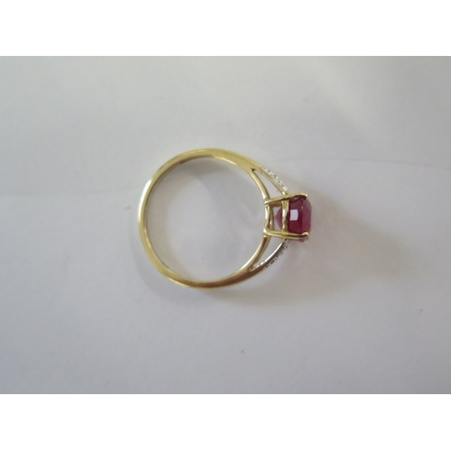 135 - A 9ct yellow gold ruby and diamond ring, head size approx 16mm x 9mm - ring size approx R - In good ... 