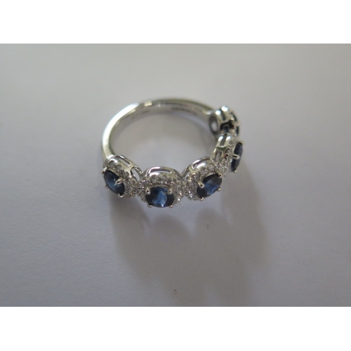 144 - A platinum 5 stone sapphire and diamond ring, the sapphires are well matched and of a good colour, d... 