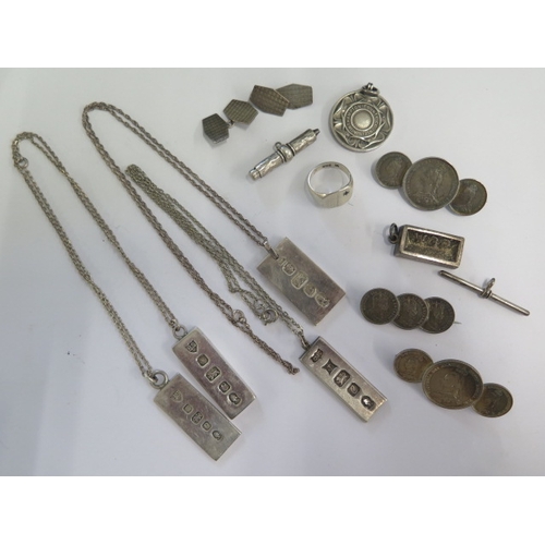 147 - A collection of silver and white metal jewellery including four ingot pendants, three coin brooches,... 