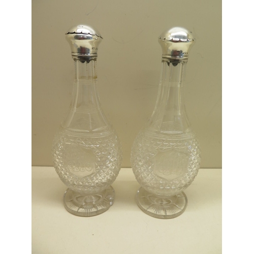 151 - A pair of silver top cut glass pourers with umbrella insert tops London 1890/91 - Height 24cm - etch... 