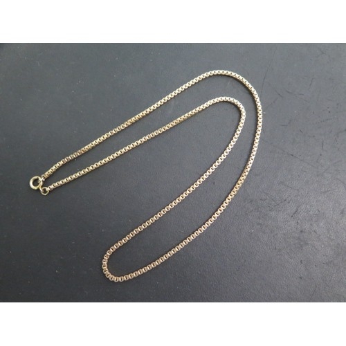 16 - A yellow metal 61cm chain - tests to approx 9ct, approx weight 21.9 grams - in good condition
