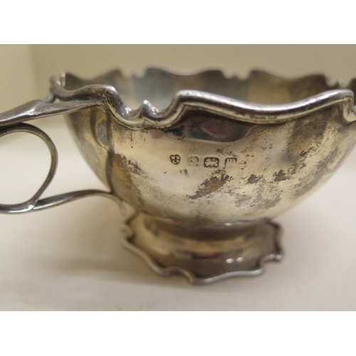 163 - A silver twin handle bowl - Width 18cm - two silver cruet, a silver back brush and mirror - weighabl... 