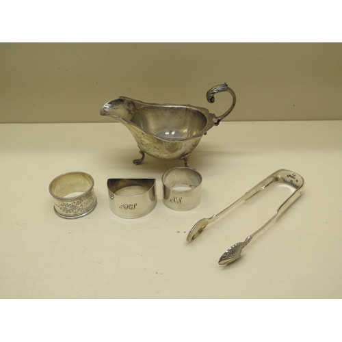 166 - A silver sauce boat, three silver napkin rings and a Victorian silver sugar nip - total approx weigh... 