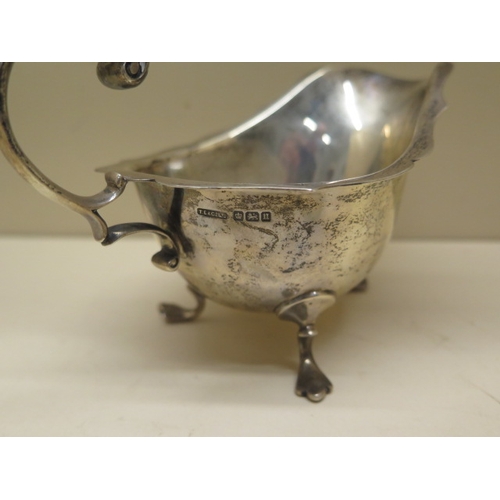 166 - A silver sauce boat, three silver napkin rings and a Victorian silver sugar nip - total approx weigh... 