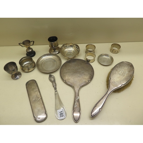 182 - A collection of silver items including serviette rings, silver back brush and mirror etc - total wei... 