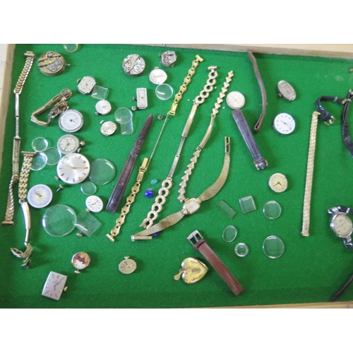 203 - A collection of assorted watch movements and parts including two Omega watch movements