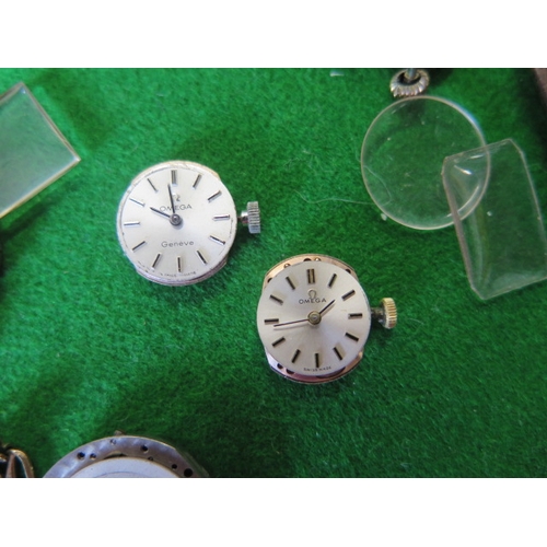 203 - A collection of assorted watch movements and parts including two Omega watch movements