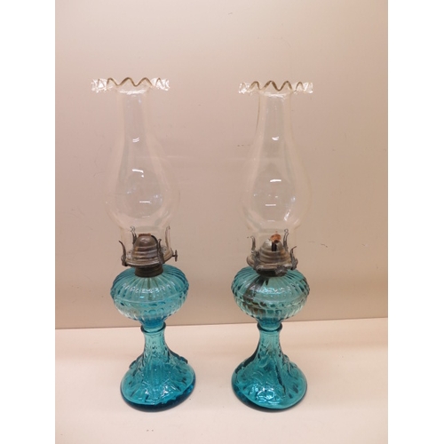 262 - A pair of blue glass oil lamps with matching shades - Height 43cm - both generally good