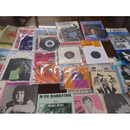 266 - A collection of 25 45rpm pop records with related magazines including Tom Jones, The Ivy League, Dav... 