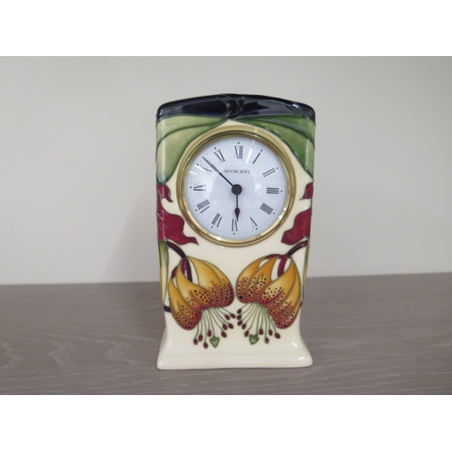 283 - A Moorcroft quart mantle clock - Height 16cm - needs new battery