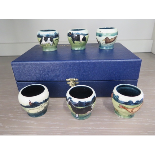 286 - A boxed Moorcroft set of six Farmyard design egg cups by Anji Davenport, signed - all in good condit... 