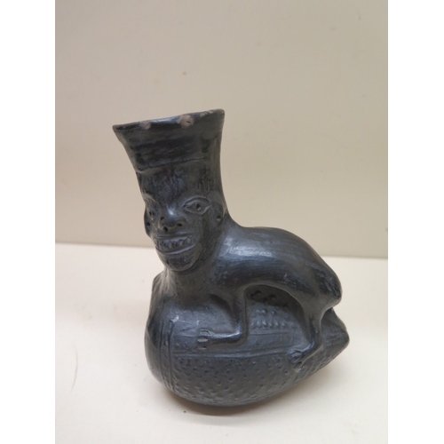 293 - A Pre-Columbian or later black ware vessel with a human faced animal, 12cm tall, sound condition, ch... 