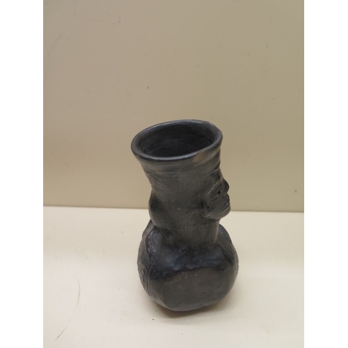 293 - A Pre-Columbian or later black ware vessel with a human faced animal, 12cm tall, sound condition, ch... 