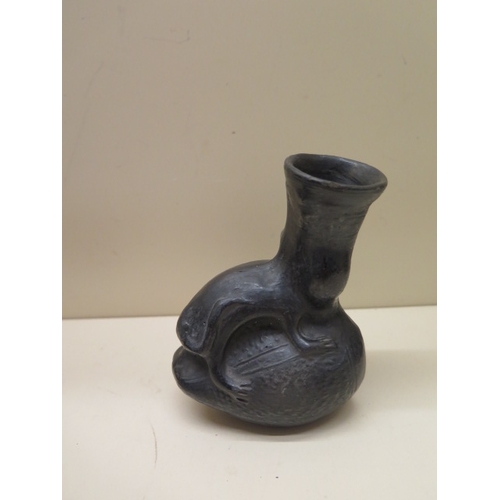 293 - A Pre-Columbian or later black ware vessel with a human faced animal, 12cm tall, sound condition, ch... 