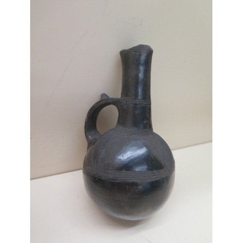 294 - A Pre-Columbian or later black ware flask with leaf decoration, 17cm tall damage to top and a polych... 