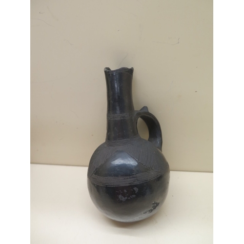 294 - A Pre-Columbian or later black ware flask with leaf decoration, 17cm tall damage to top and a polych... 