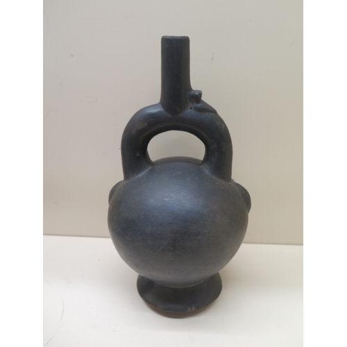 296 - A Pre-Columbian or later black ware pottery stirrup pot with bird detail, crack to base, possible re... 