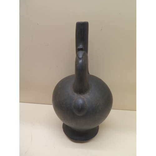 296 - A Pre-Columbian or later black ware pottery stirrup pot with bird detail, crack to base, possible re... 