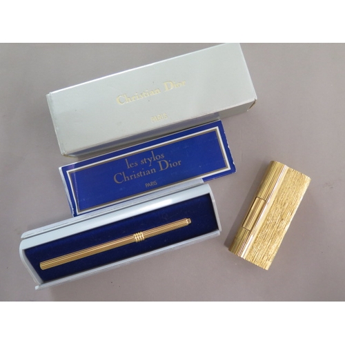 298 - A Dunhill gold plated lighter with damage flint holder and a Christian Dior pen case - Length 9.5cm ... 