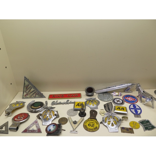 369 - A collection of 26 motoring/car badges, a Rocket mascot and an Ariel Centenary nut cracker