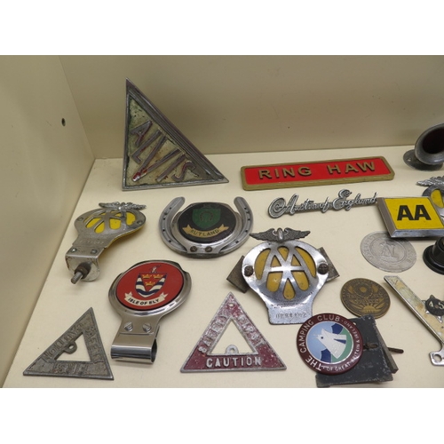 369 - A collection of 26 motoring/car badges, a Rocket mascot and an Ariel Centenary nut cracker