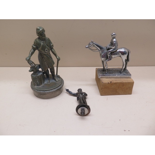 377 - Three figural car mascots - Dart player, Jockey and horse and Blacksmith - Height 14cm